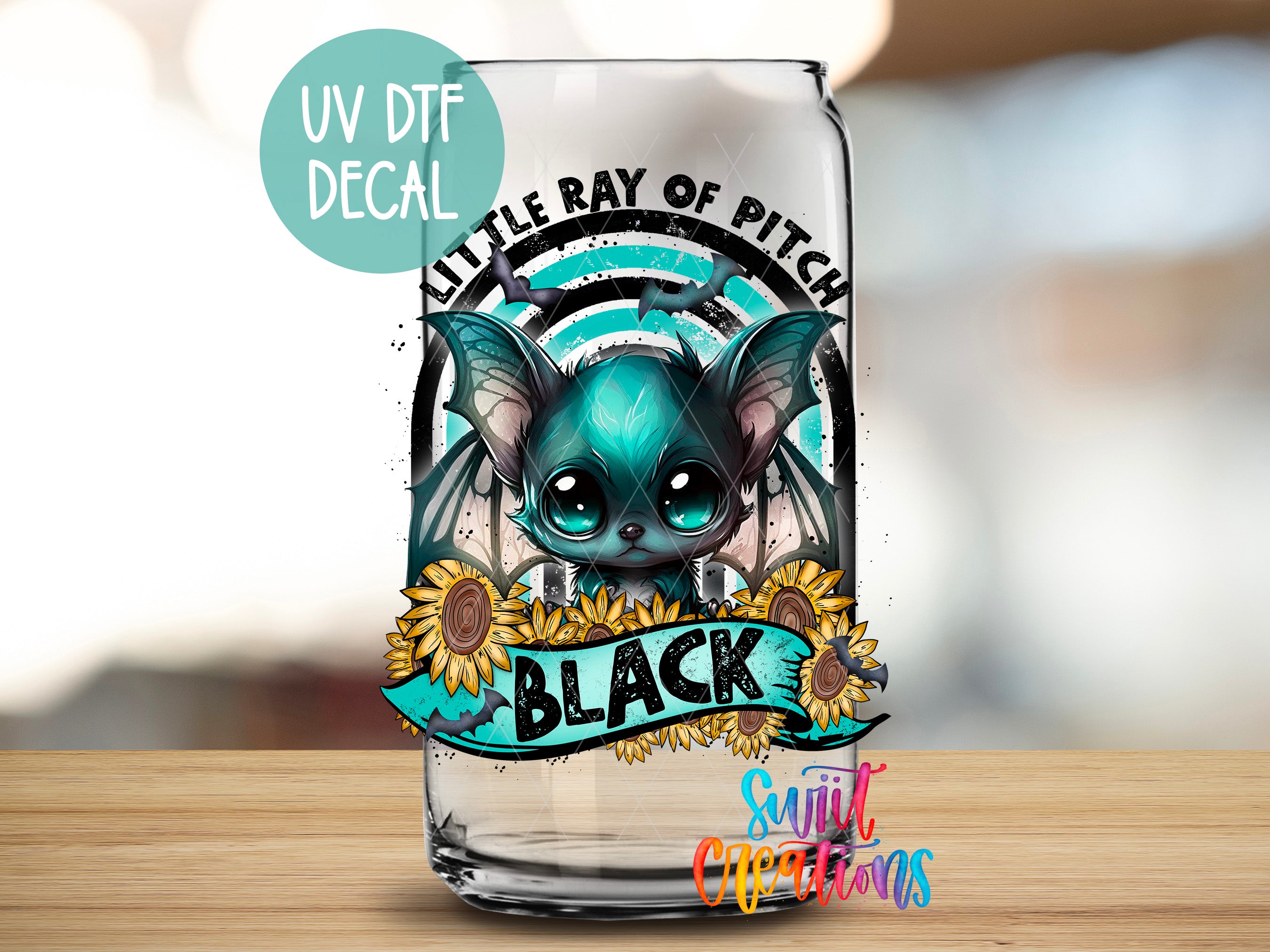 A glass can with a UV decal featuring a bat-like creature with large eyes and a black body, surrounded by sunflowers and the word "BLACK".