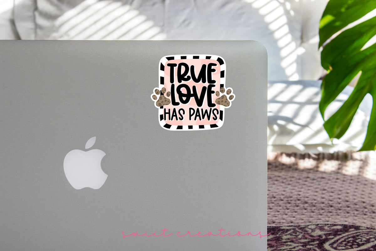 True Love Has Paws sticker on the lid of a silver laptop