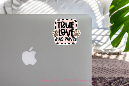 True Love Has Paws sticker on the lid of a silver laptop