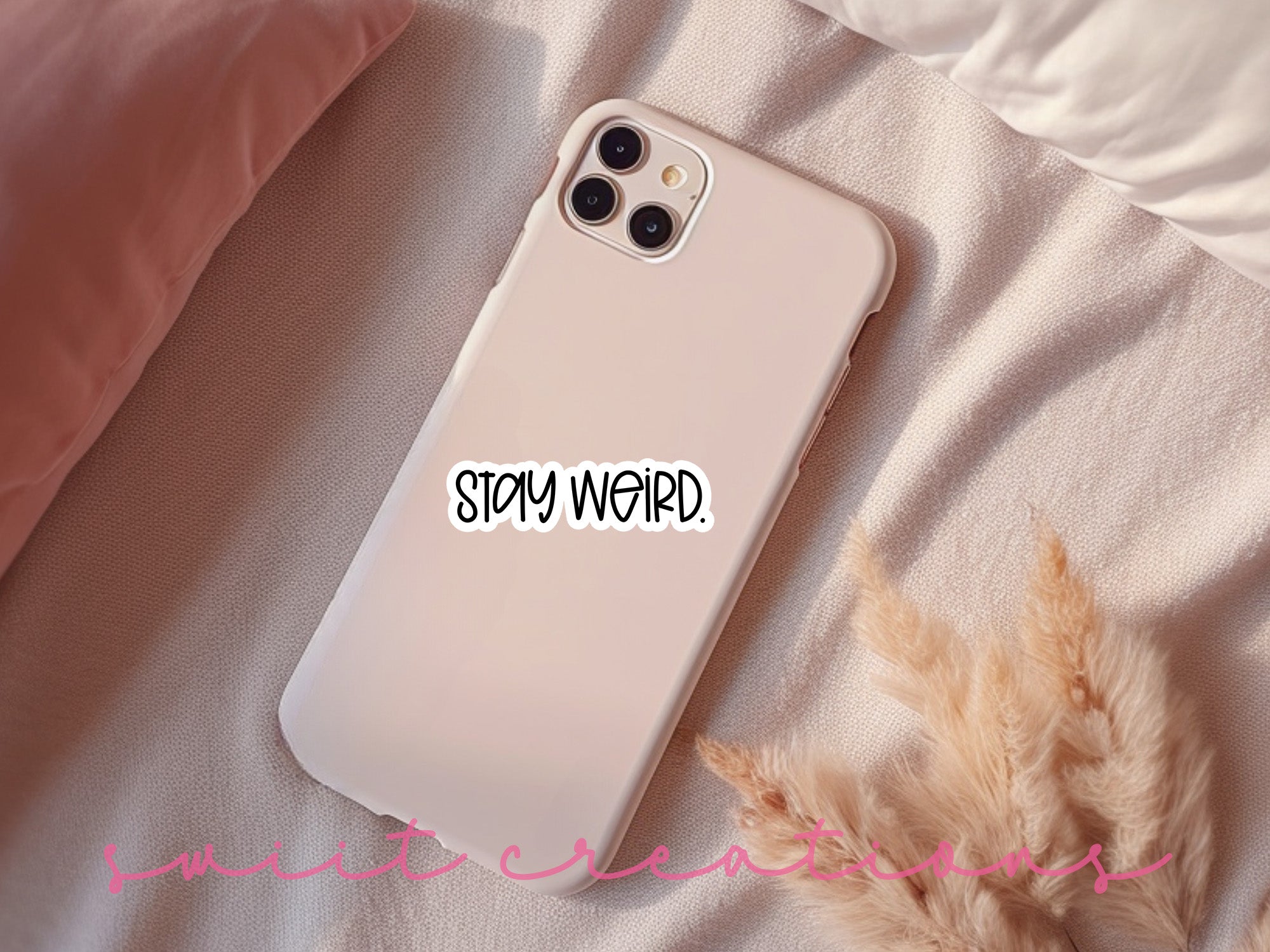 a white iphone case with a sticker that says, stay weird