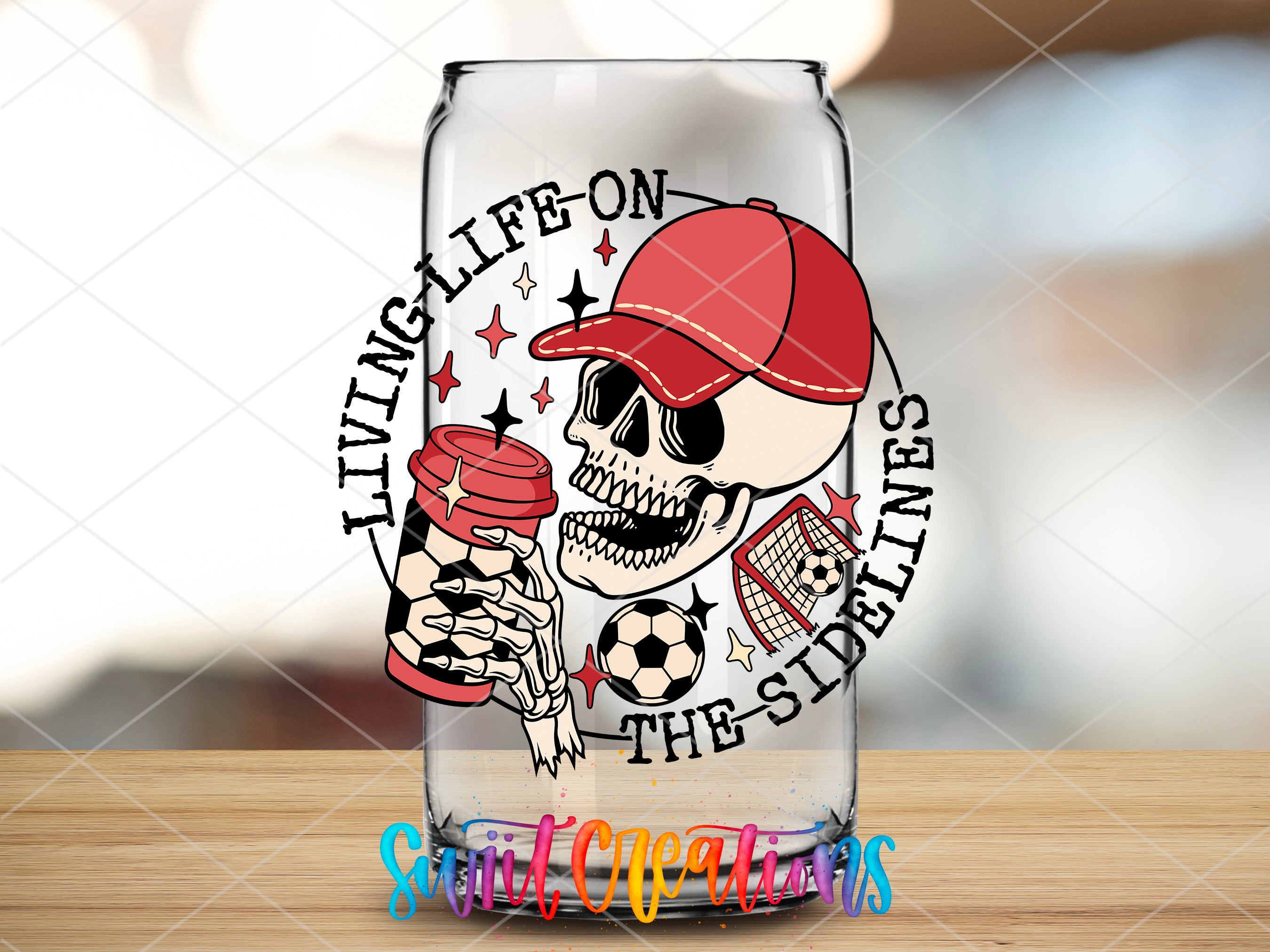 a glass with a skull holding a soccer ball