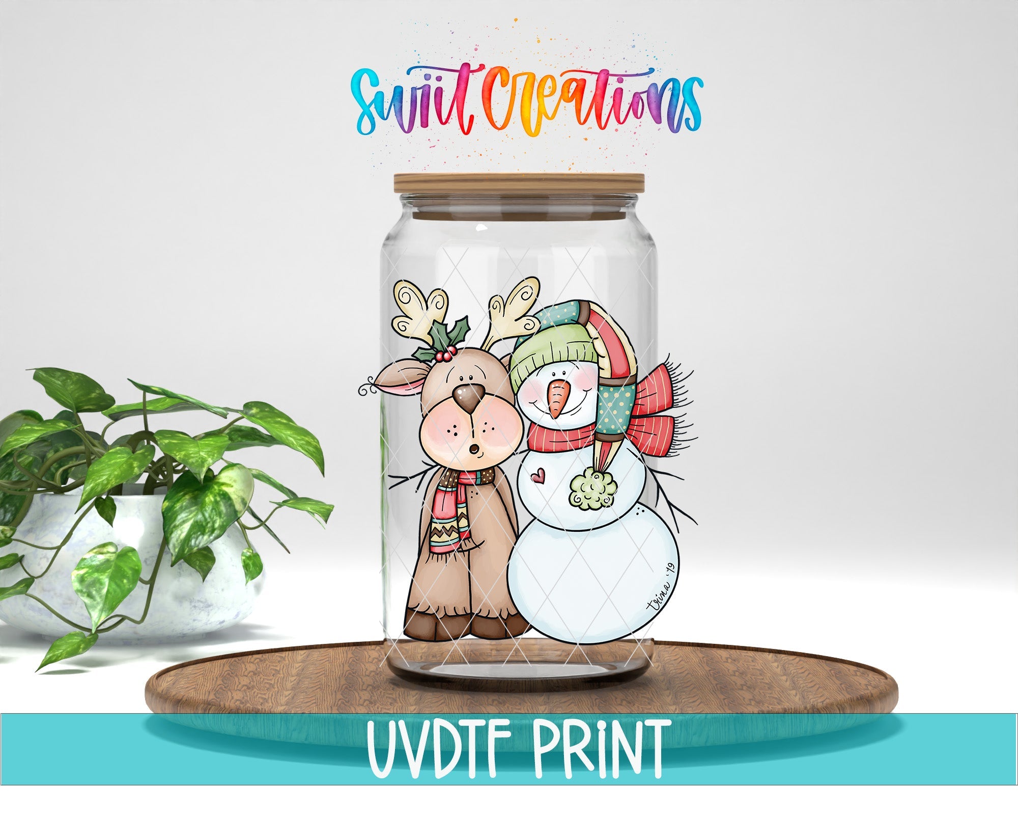 a glass jar filled with a snowman and a reindeer