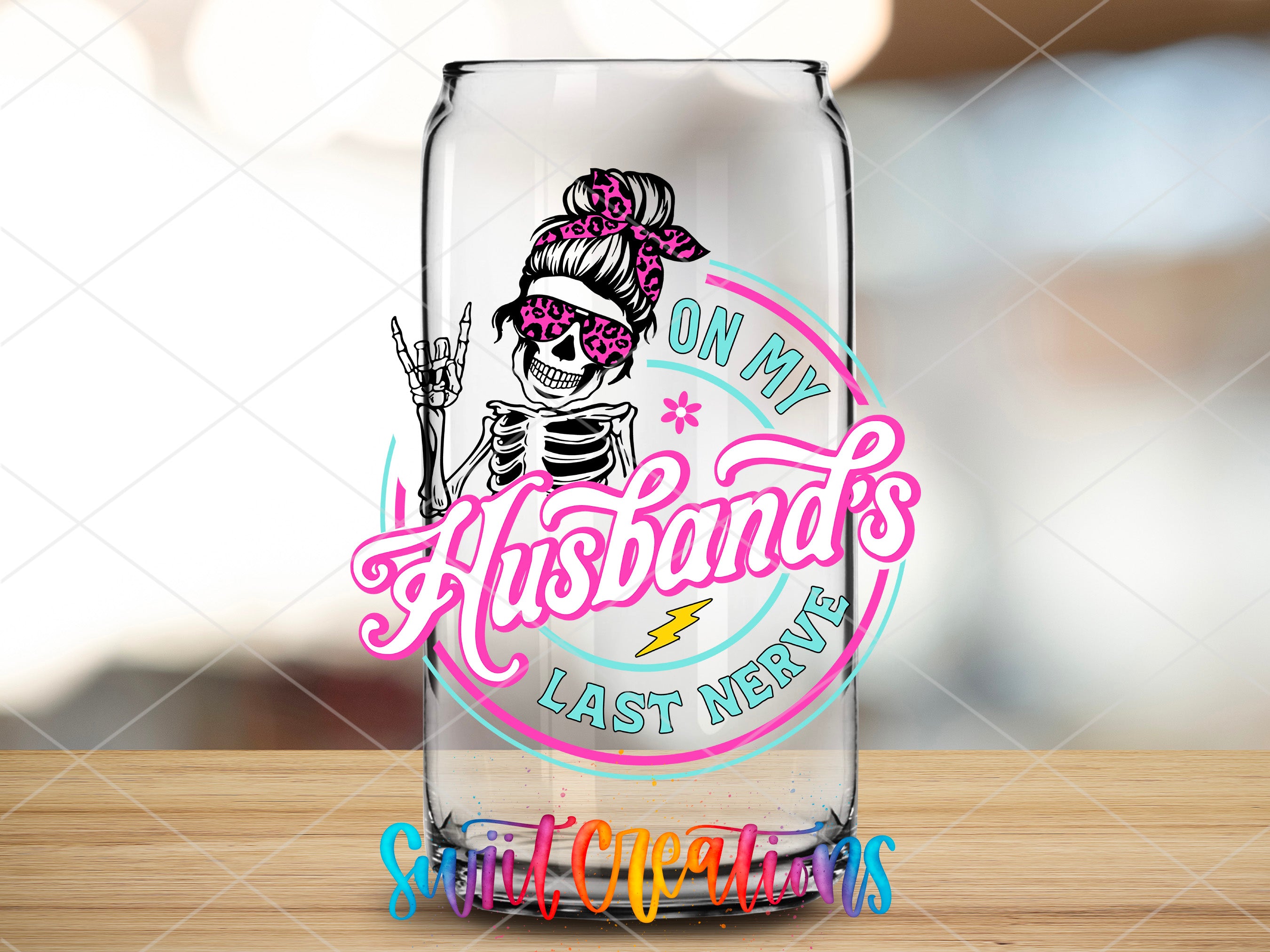 a glass with a sticker on it sitting on a table