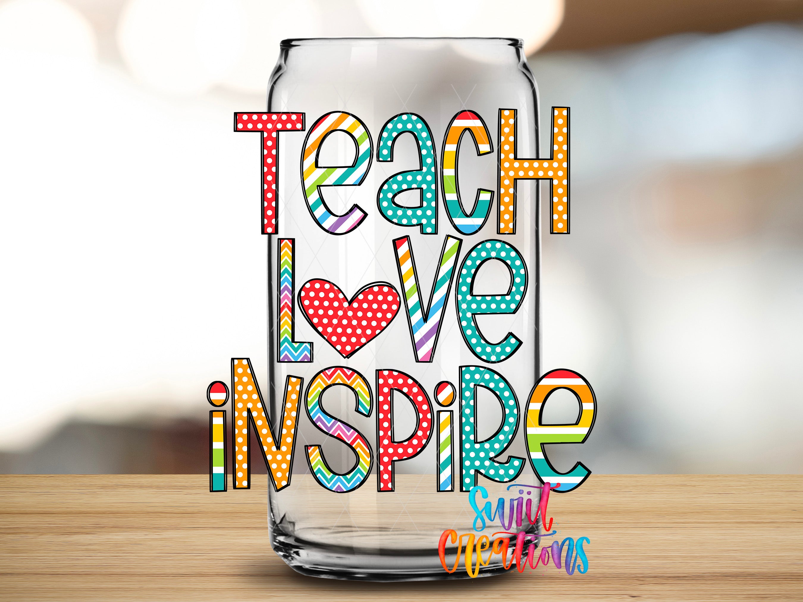 a glass can with colorful text on it, which reads "Teach Love Inspire".