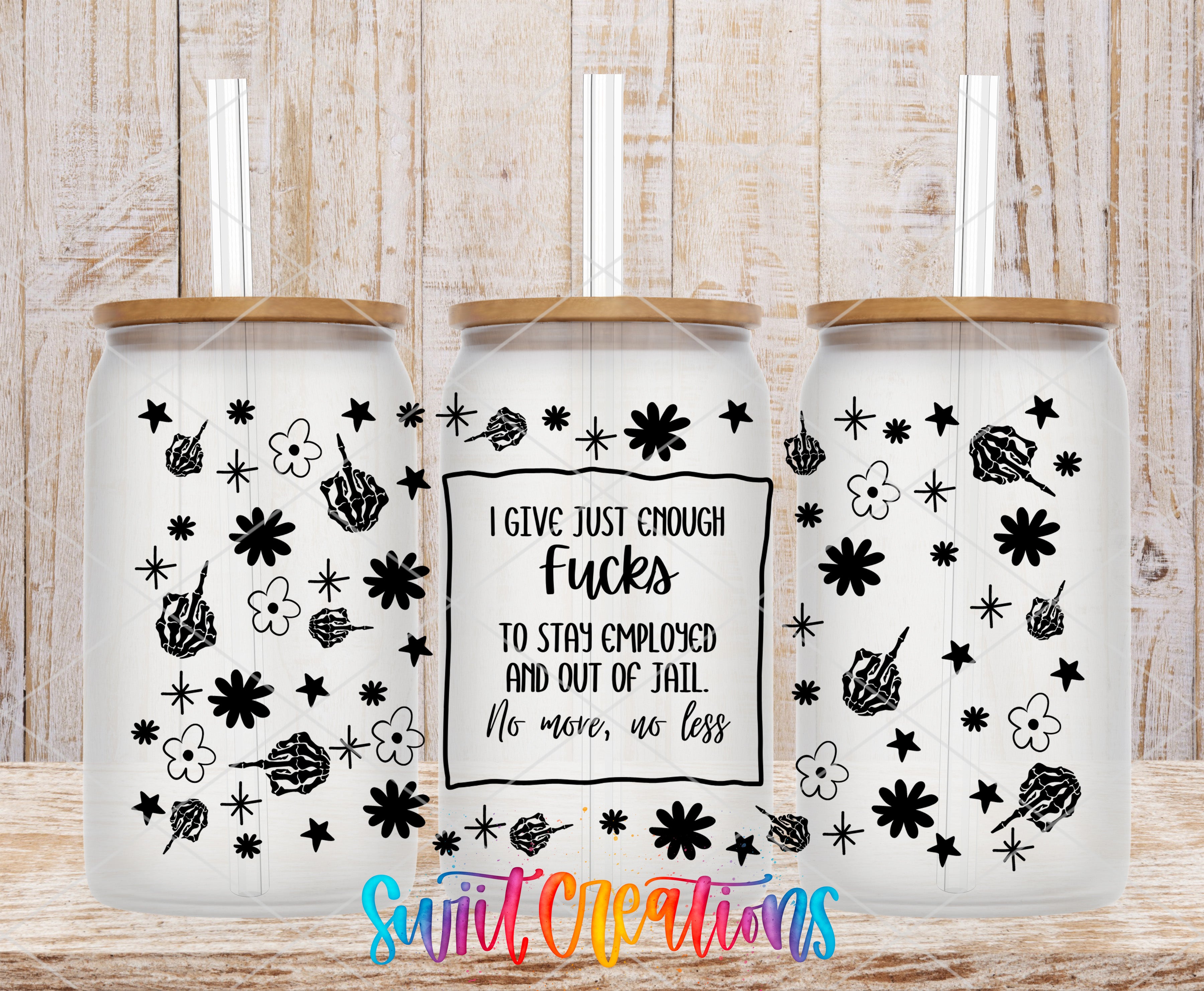 three white glass tumblers with black designs and text on them.