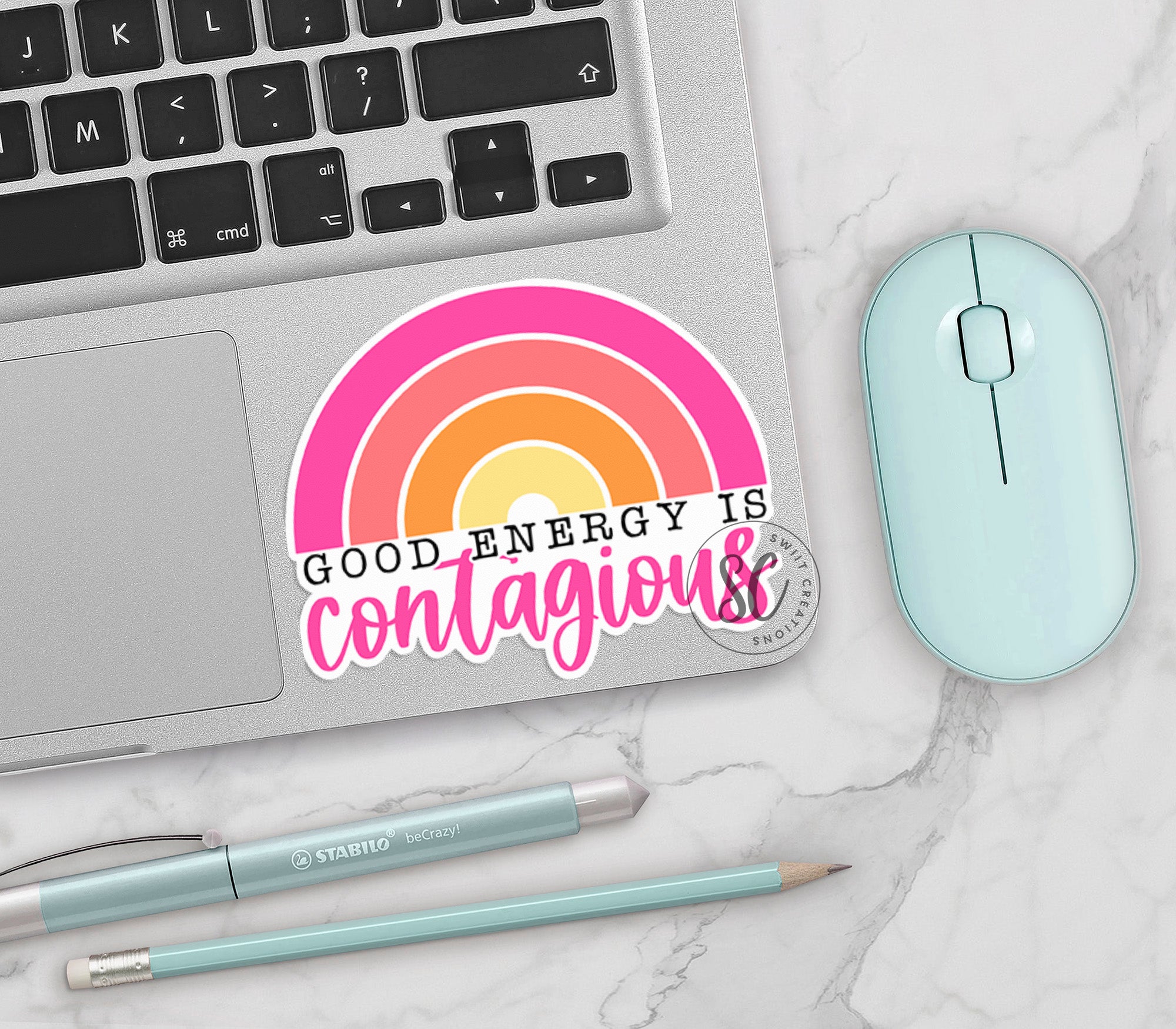 a laptop with a sticker that says, god energy is contagious