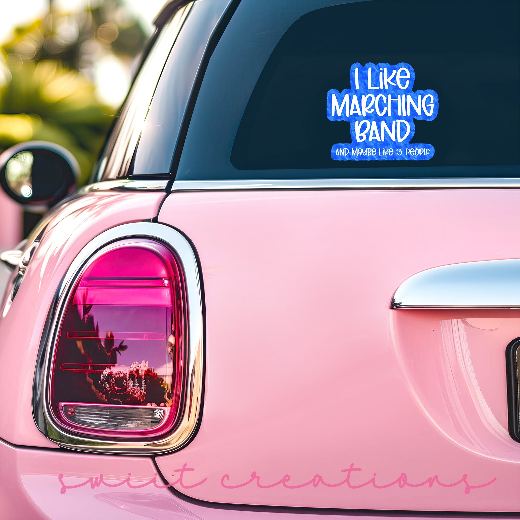 a pink car that has a sticker on it
