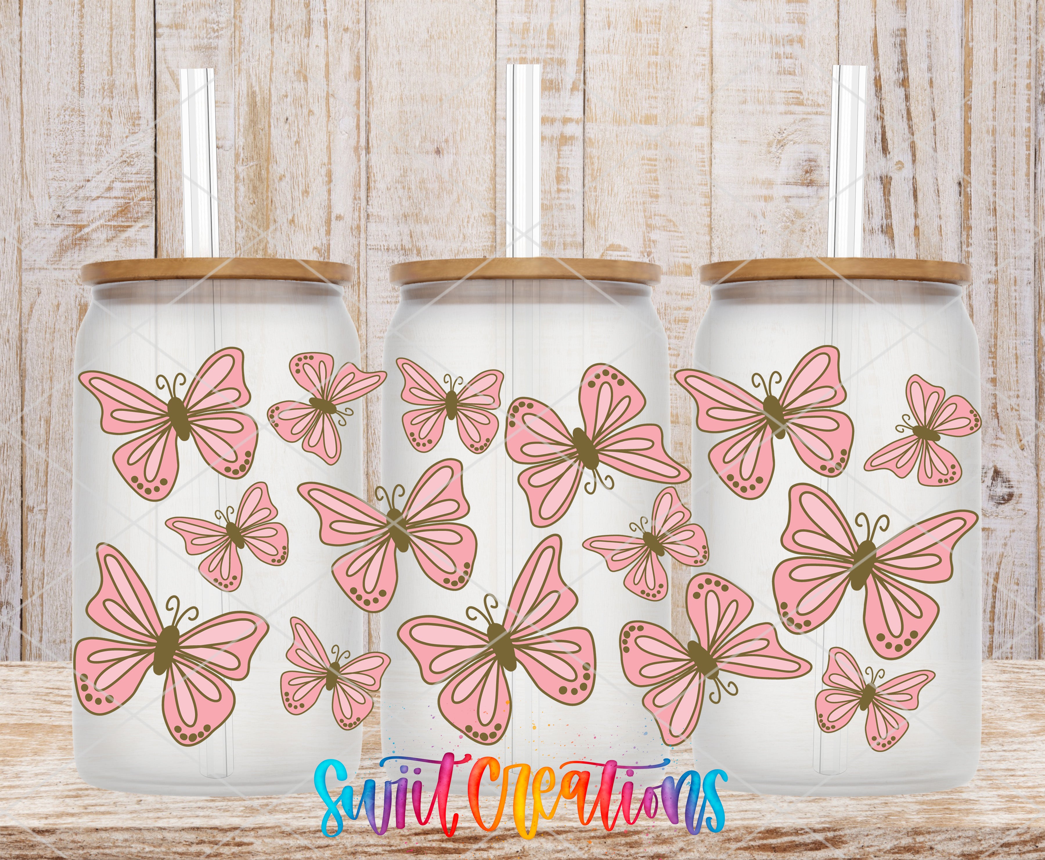 Three glass jars with lids, each decorated with pink butterflies.
