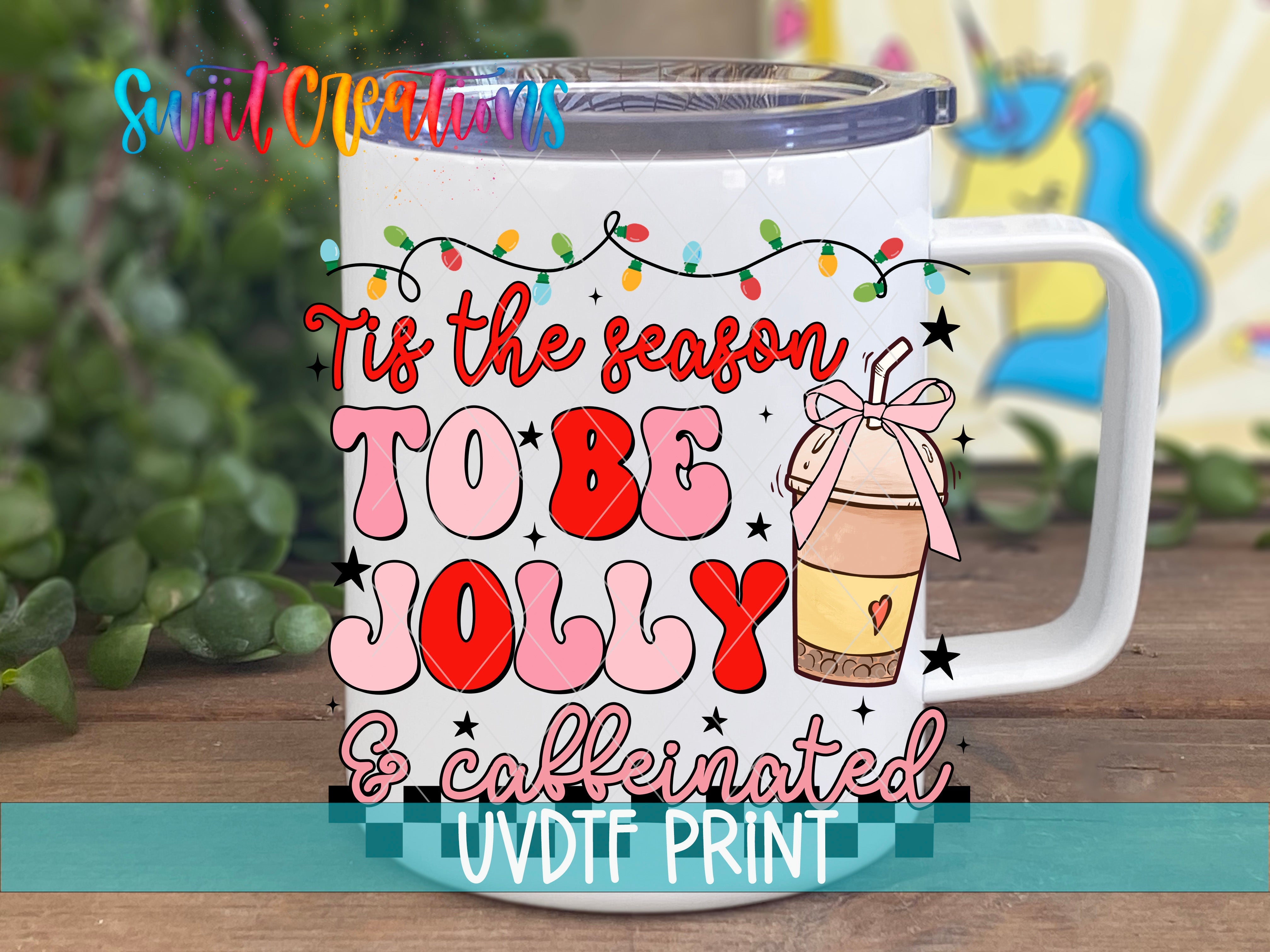 a white coffee mug with the words tis the season to be jolly and cookie