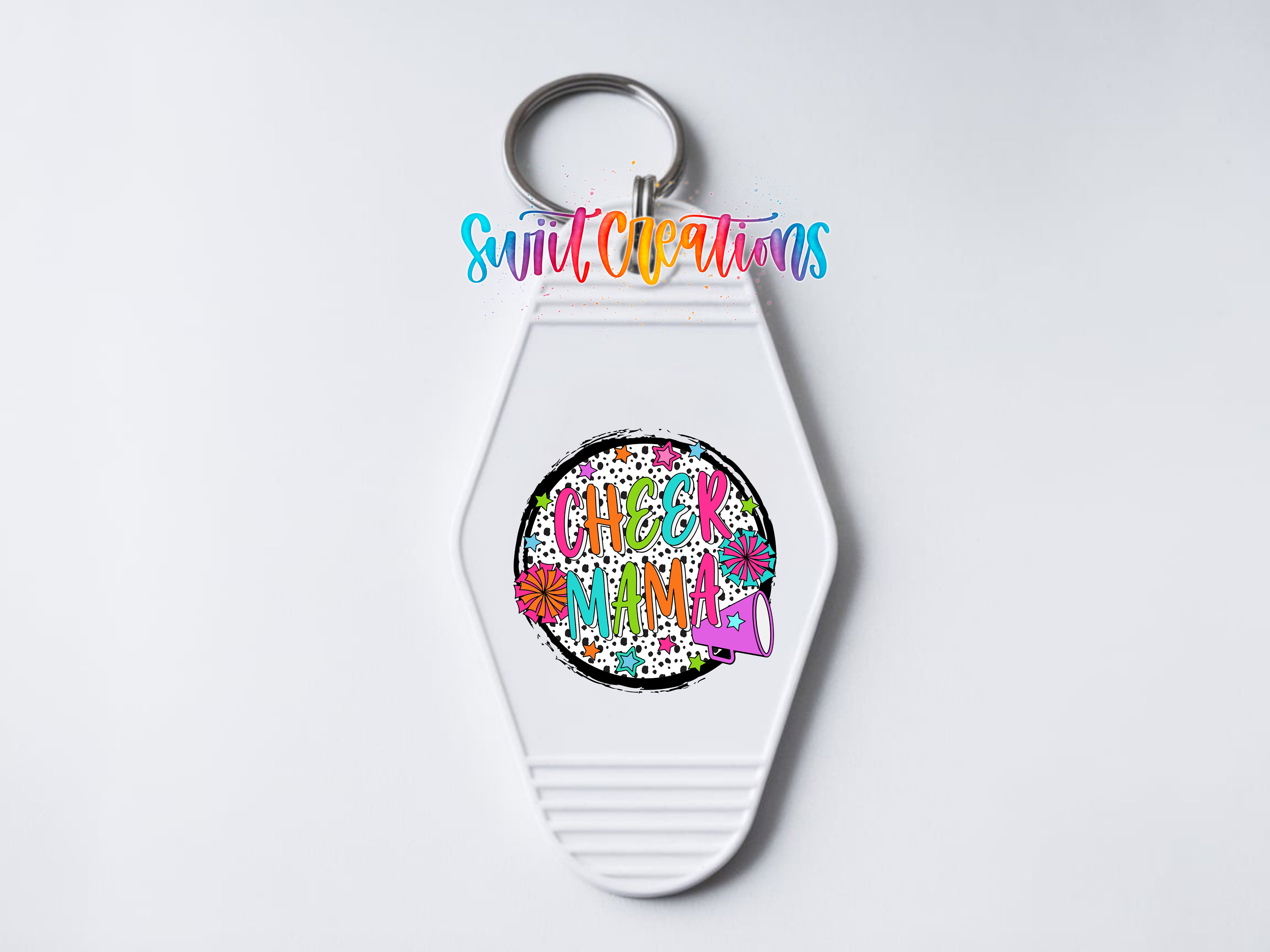 A keychain with a colorful design featuring the word "CHEER" surrounded by various decorative elements.