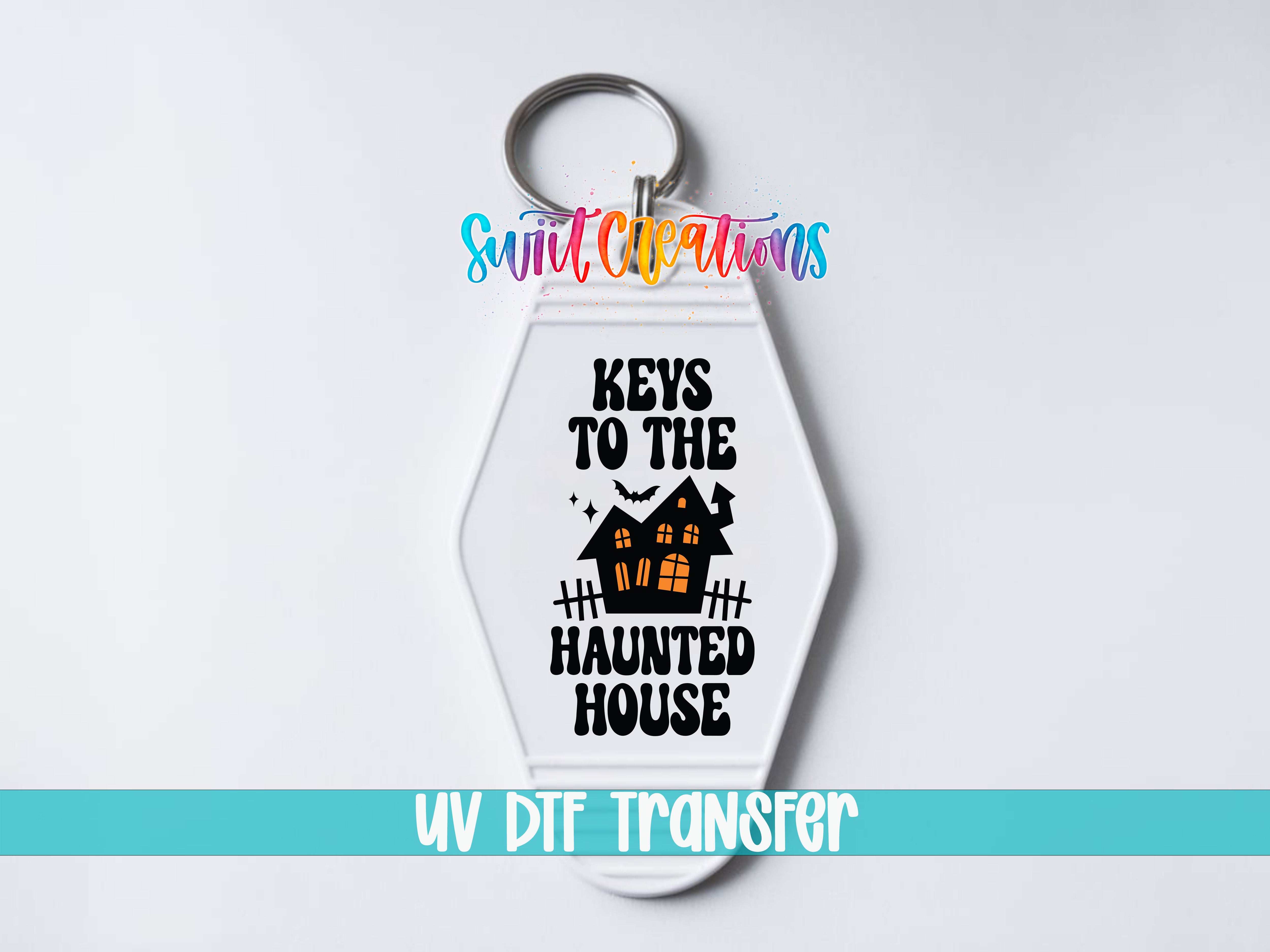 A keychain with a Halloween-themed design, including a house and bats, along with the text "KEYS TO THE HAUNTED HOUSE" and the UV DDF Transfer logo.