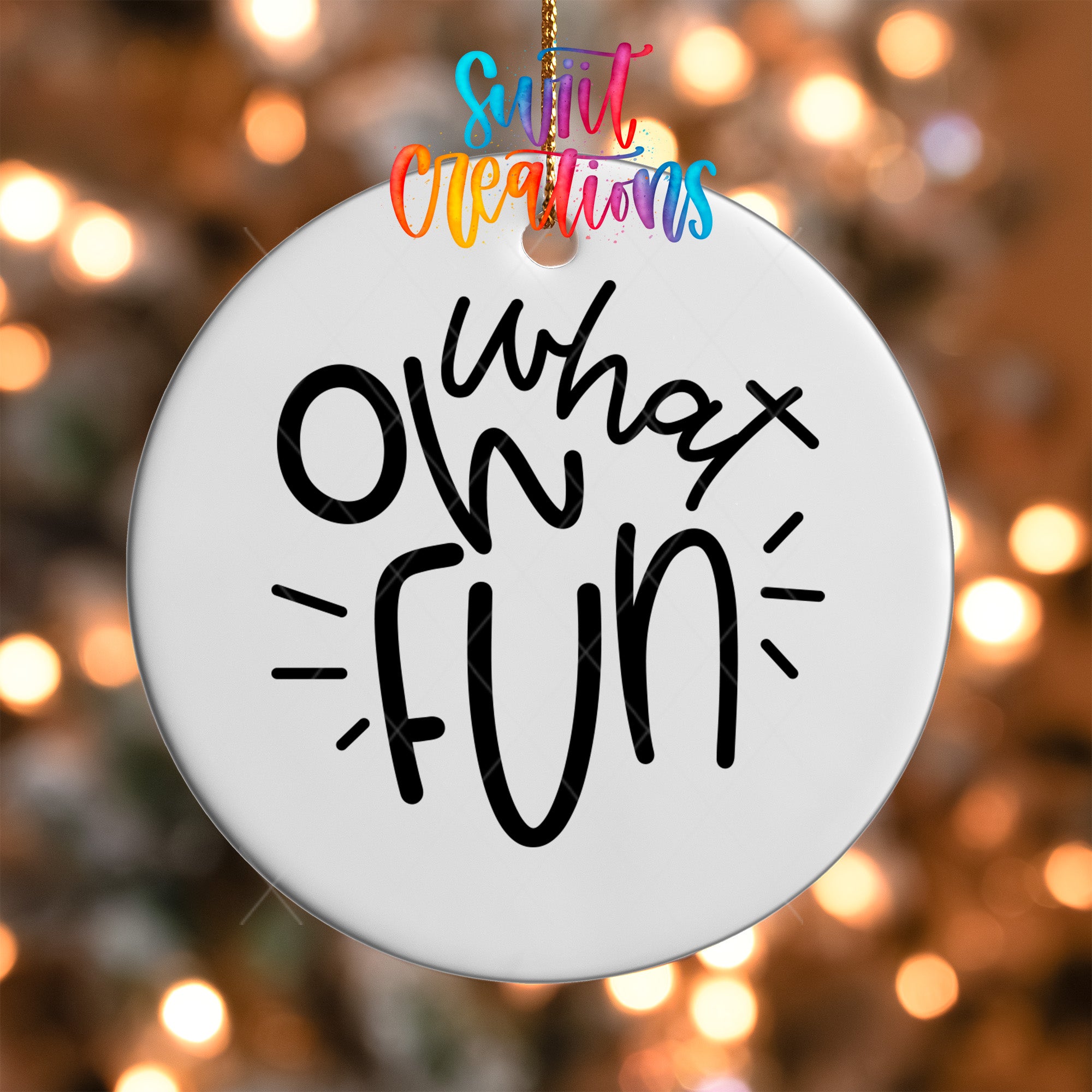 A white circular ornament with the text "What's up fun" written on it, hanging against a background of colorful lights.