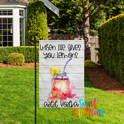 A sign in a yard with a message about adding vodka to life.