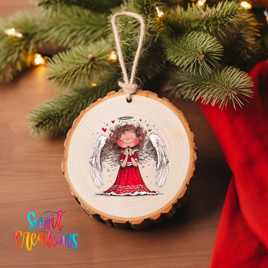 A wooden ornament featuring a smiling angel with wings, hanging on a Christmas tree.