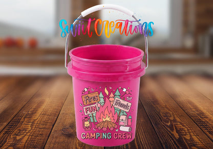 Camping Crew UV DTF transfer on a pink mini bucket on a wood table
