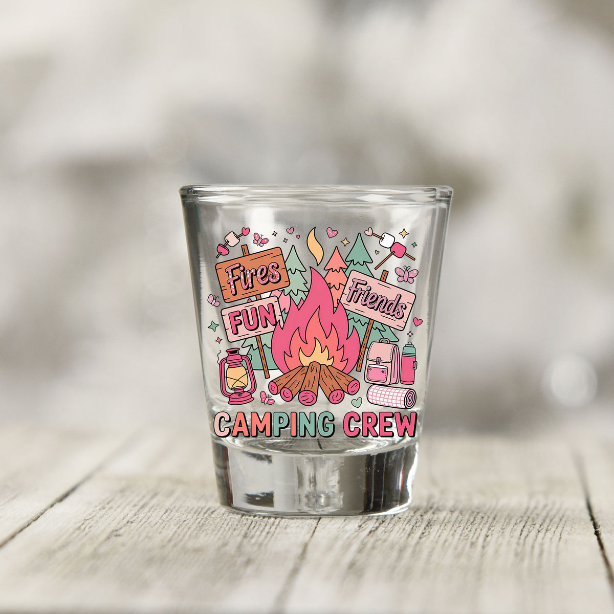 Close-up of the Camping Crew UV DTF transfer on a clear shot glass