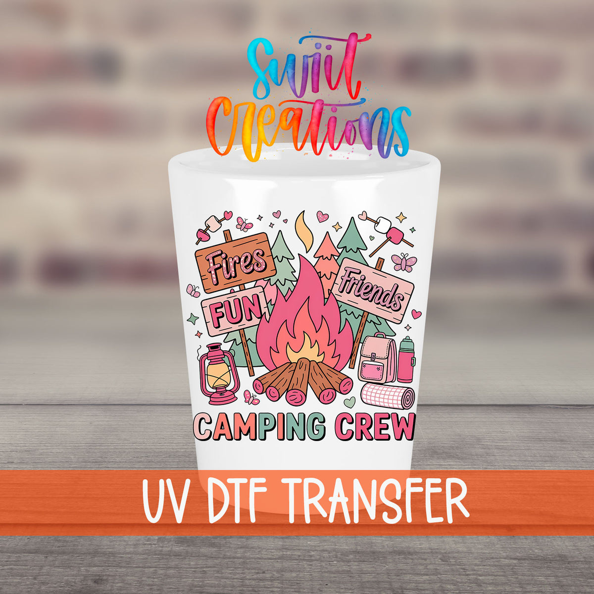 Camping Crew UV DTF transfer on a white shot glass in front of a brick wall