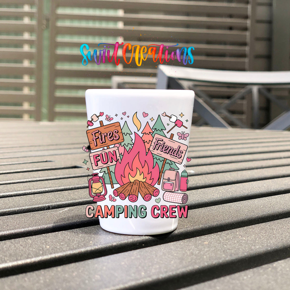 Camping Crew UV DTF transfer on a white shot glass on an outdoor patio table