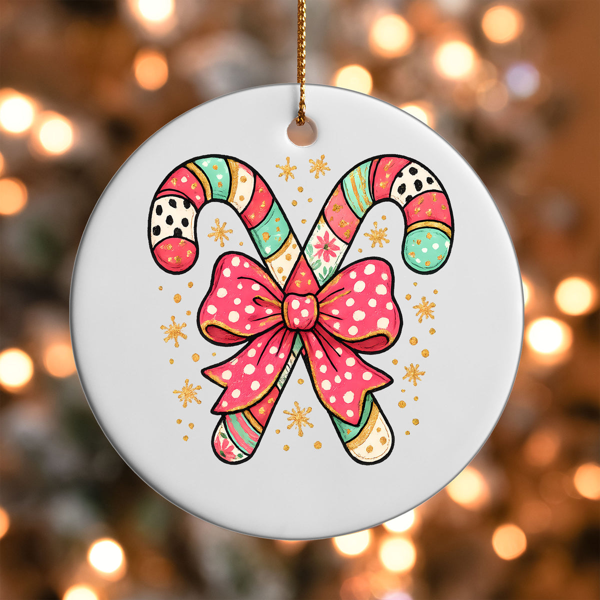 Candy Cane Bow ornament UV DTF transfer on a round white ornament with a bokeh light background