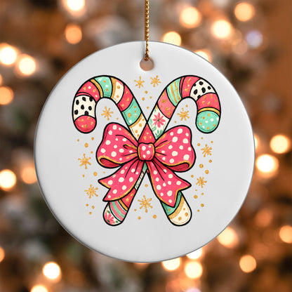Candy Cane Bow ornament UV DTF transfer on a round white ornament with a bokeh light background