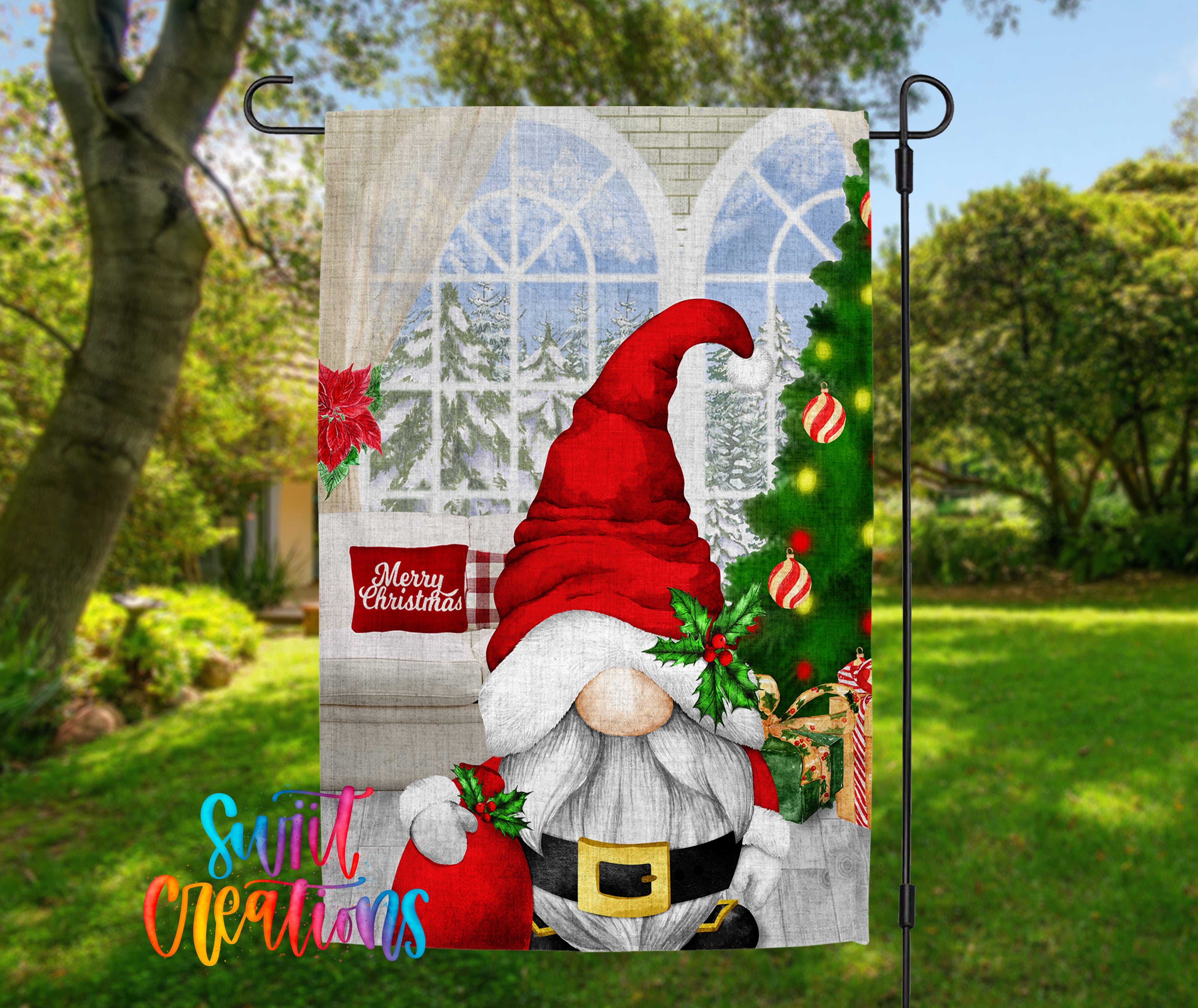 A Christmas-themed garden flag featuring a gnome wearing a Santa hat and holding a Christmas tree, with a "Merry Christmas" sign in the background.