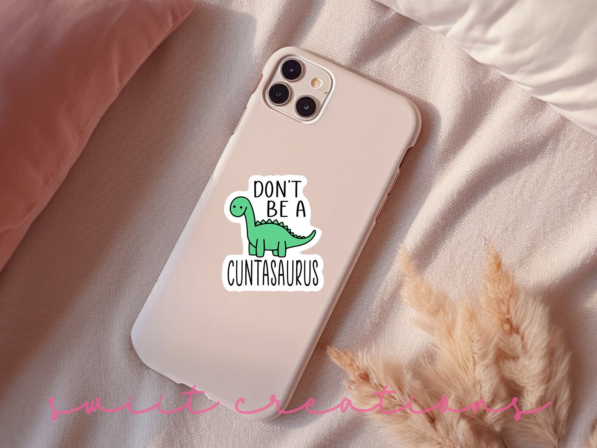 a phone case with a sticker of a dinosaur