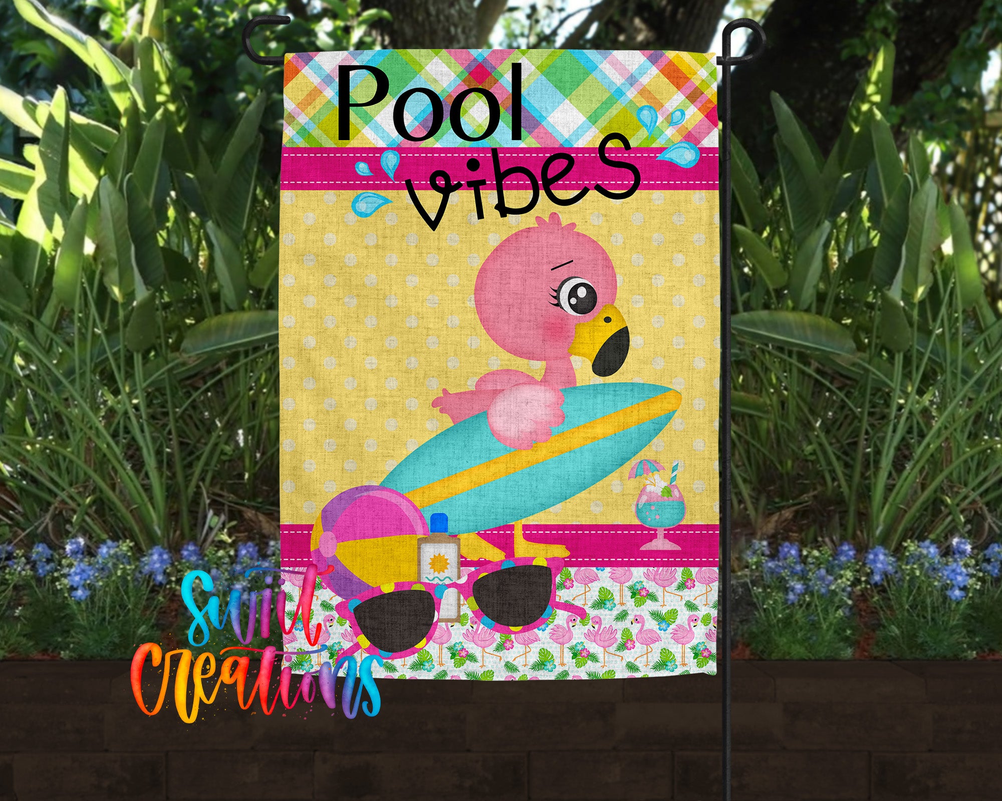 A colorful poolside-themed garden flag featuring a pink flamingo, sunglasses, and a surfboard, with the text "Pool vibes" and "Suit Creations" displayed.