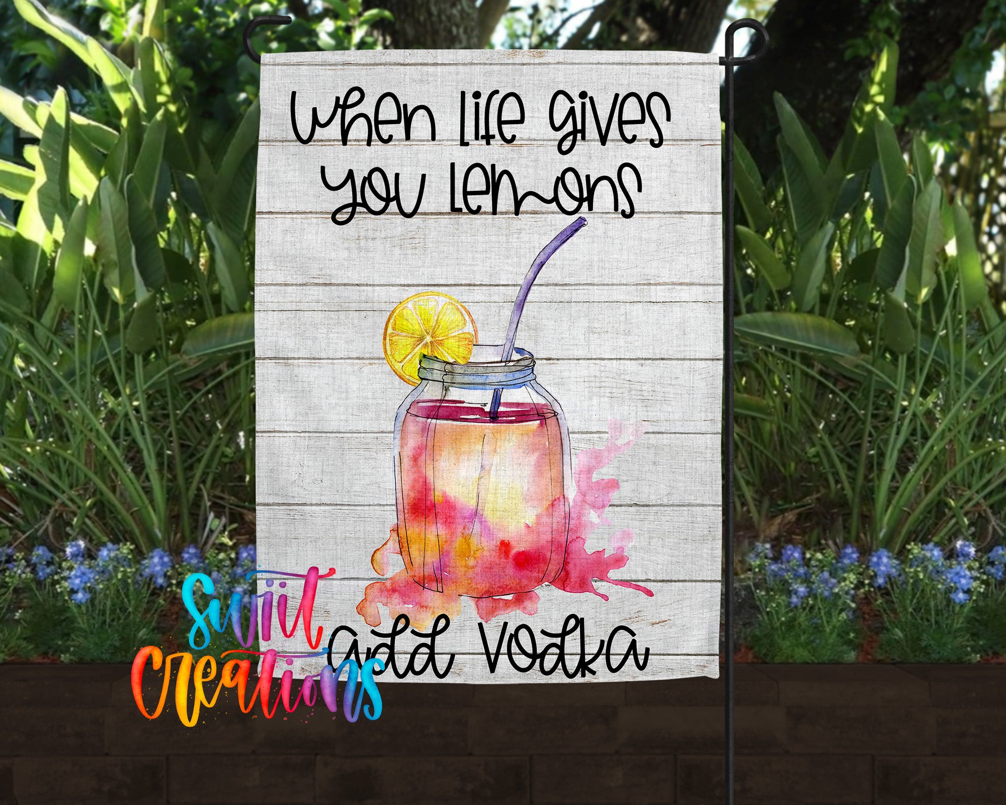 a sign with a lemon and a straw, accompanied by the text "When life gives you lemons, add vodka" in a wooden frame.