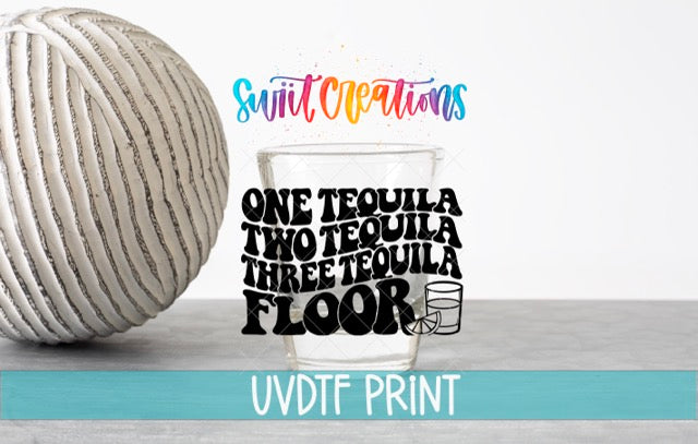 a ball of yarn next to a glass of water