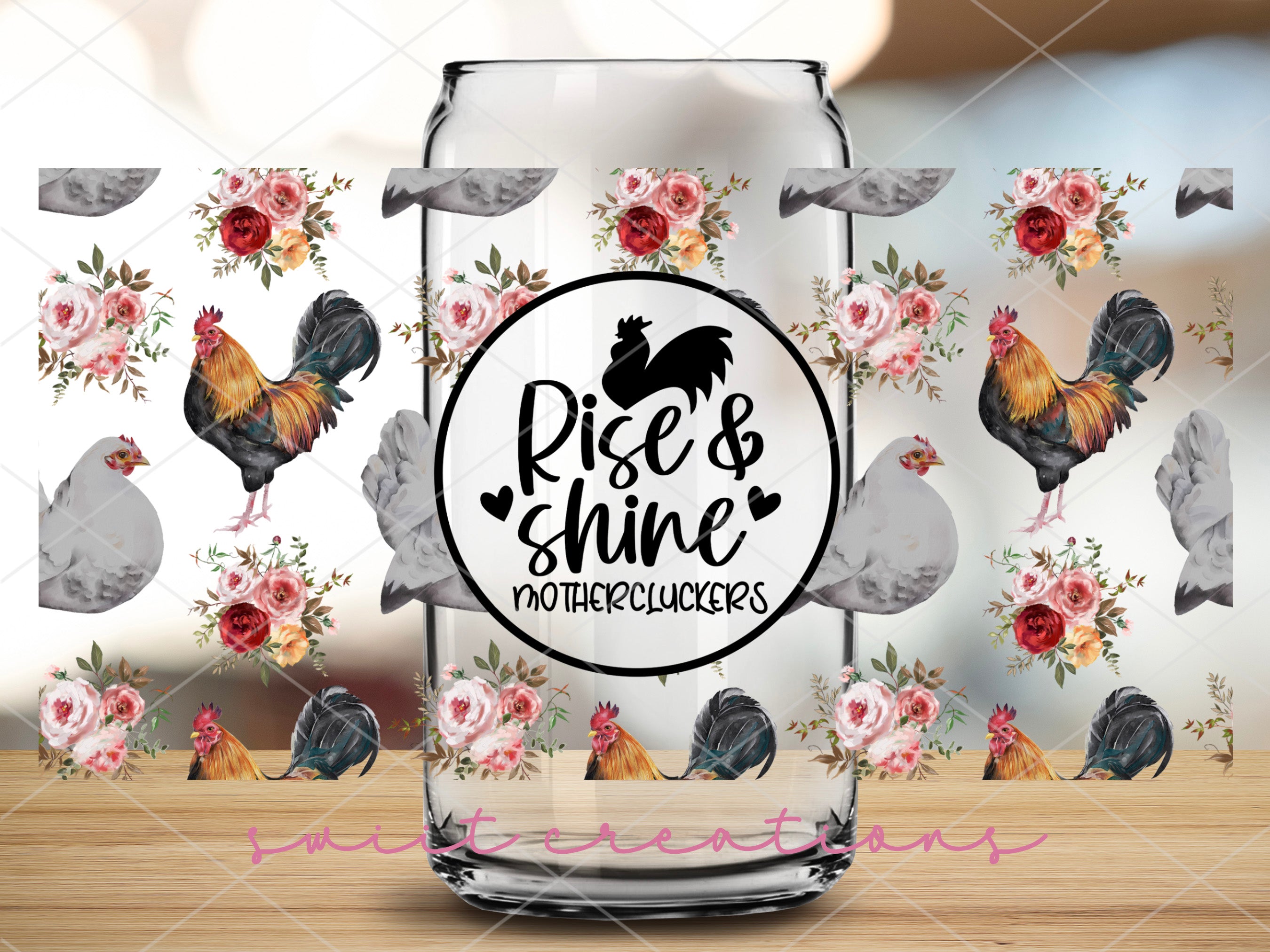 a glass jar with a rooster and flowers on it