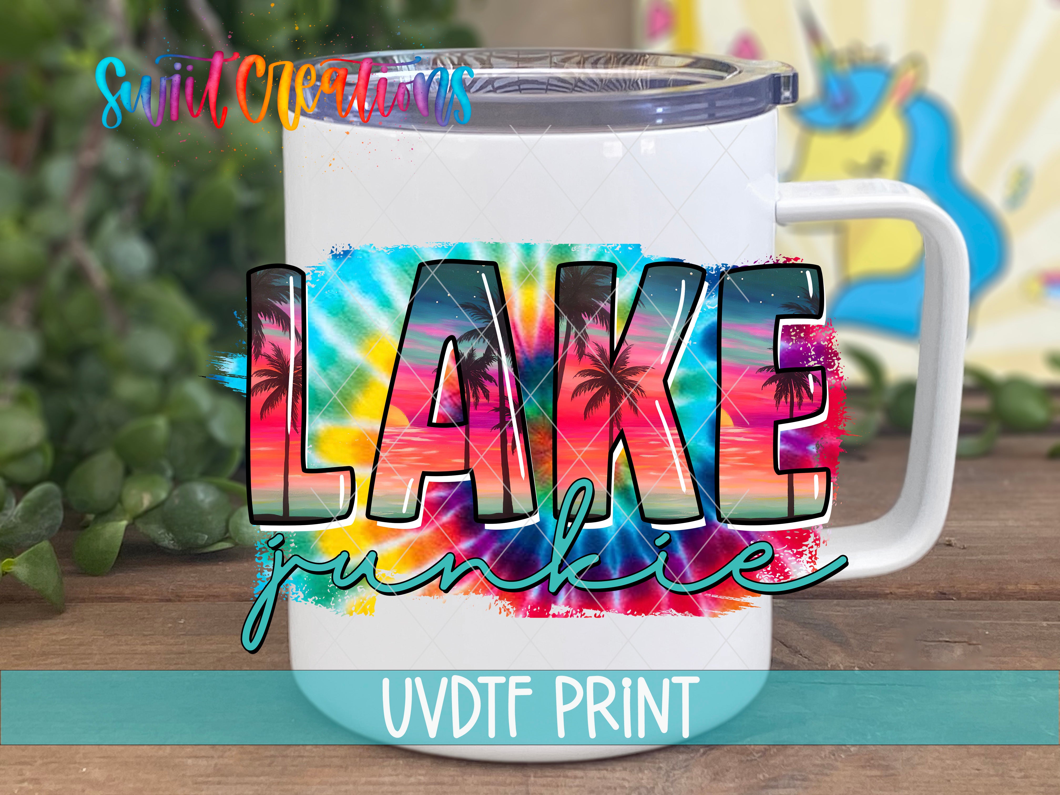 A white mug with a colorful tie-dye design that says "LAKE junkie" printed on it.