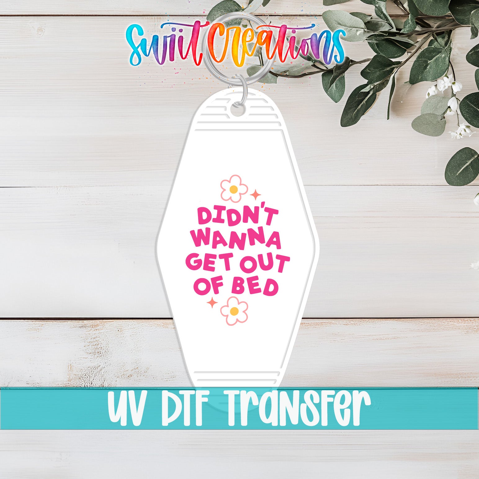 A keychain with a humorous text message that reads "Didn't Wanna Get Out of Bed"