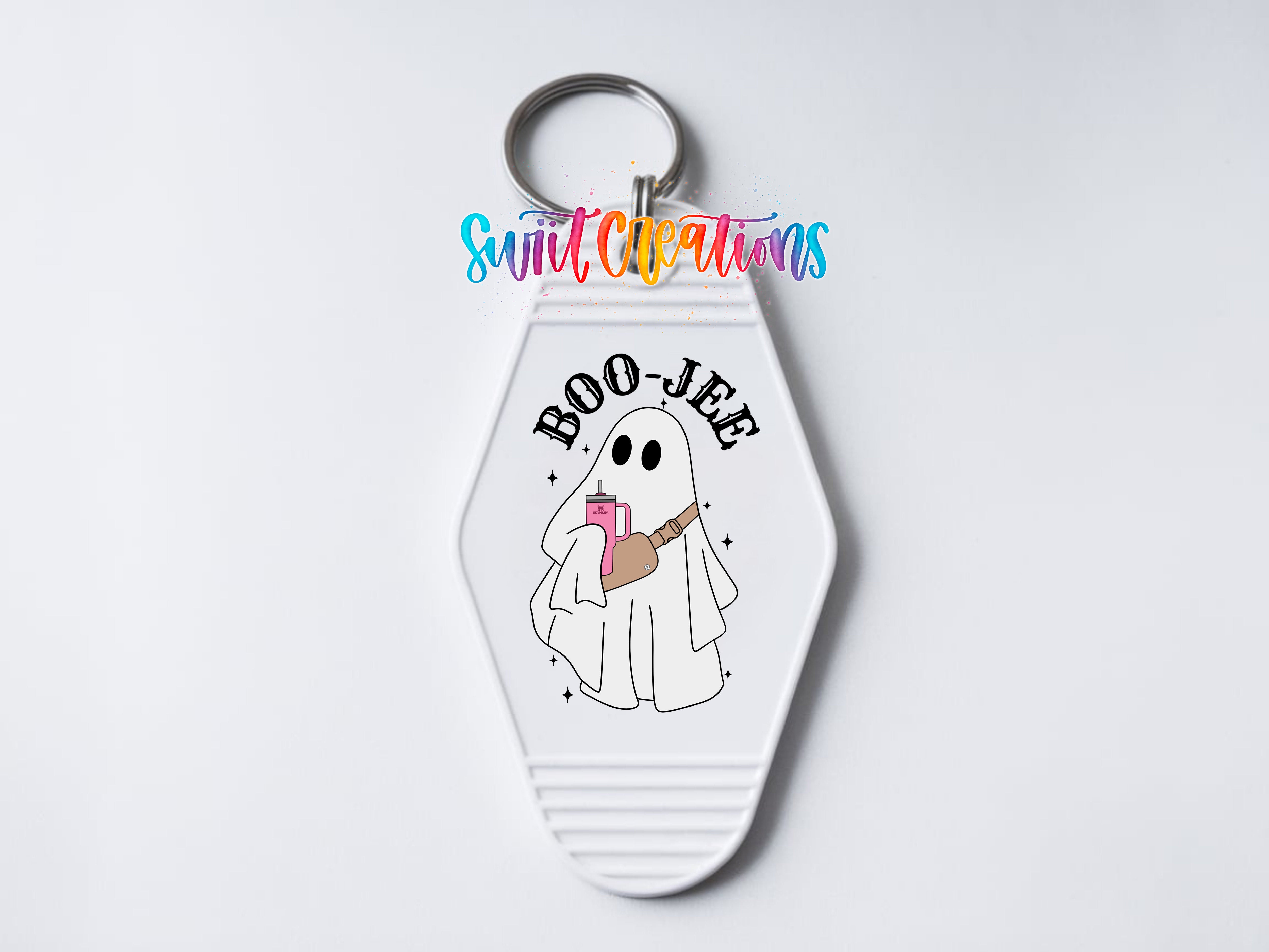 A keychain with a cartoon ghost holding a book and the text "BOO JEE" printed on it.