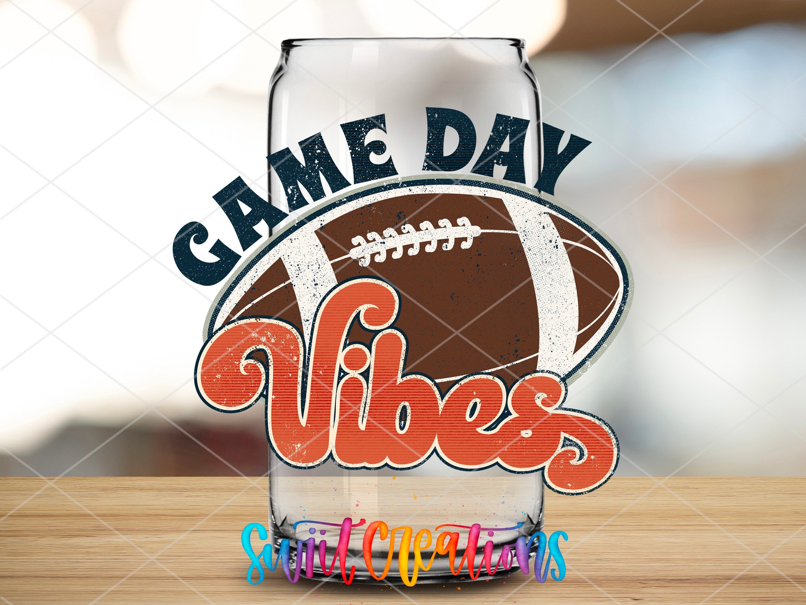 a glass with a football on it sitting on a table