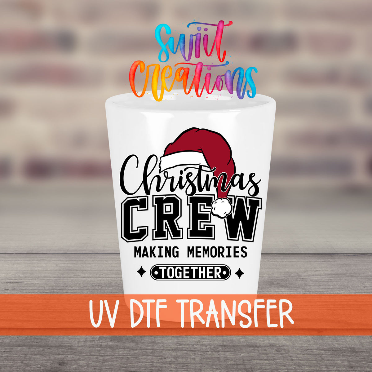 Christmas Crew Making Memories Together UV DTF transfer on a white shot glass in front of a brick wall