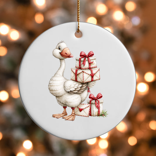Christmas Gift Goose ornament UV DTF transfer on a round white ornament with a bokeh light background