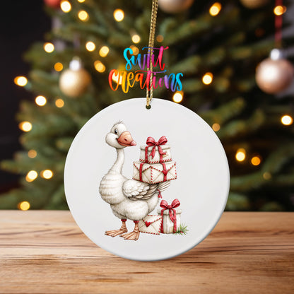 Christmas Gift Goose ornament UV DTF transfer on an ornament on a wooden table with tree lights behind it