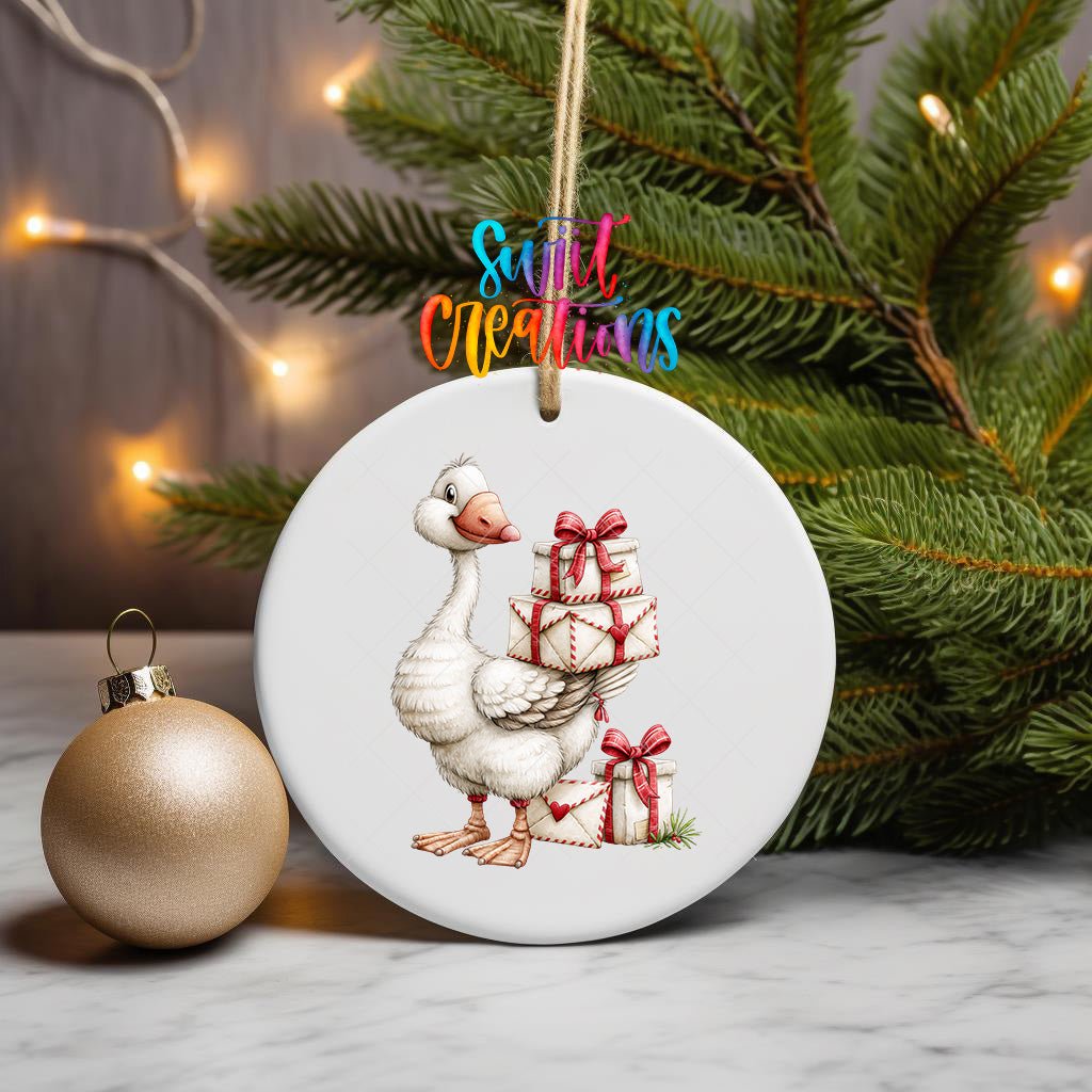 Christmas Gift Goose ornament UV DTF transfer on a hanging ornament with pine branches and a gold bauble