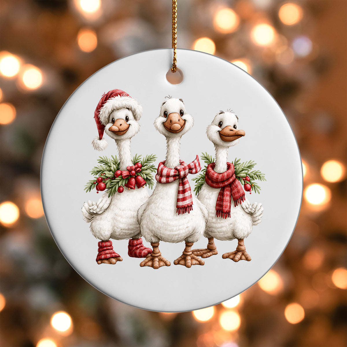 Christmas Goose Trio ornament UV DTF transfer on a round white ornament with a bokeh light background