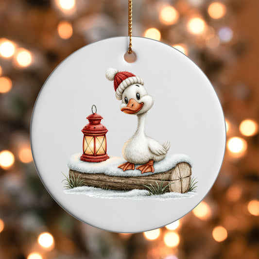 Christmas Lantern Goose ornament UV DTF transfer on a round white ornament with a bokeh light background
