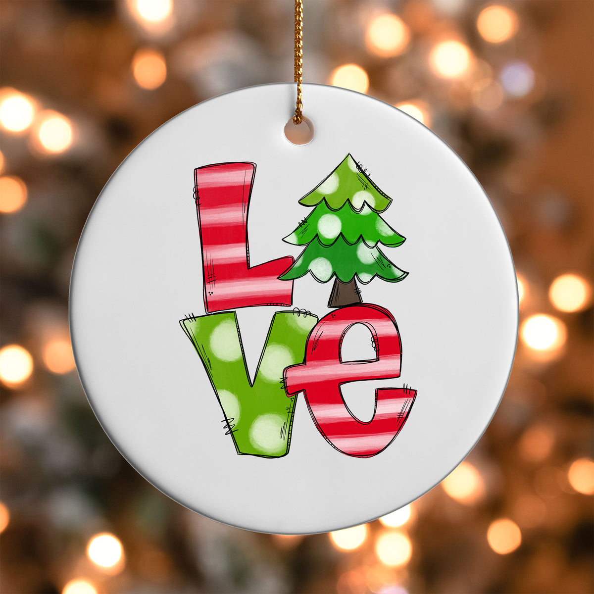 Christmas Love ornament UV DTF transfer on a round white ornament with a bokeh light background