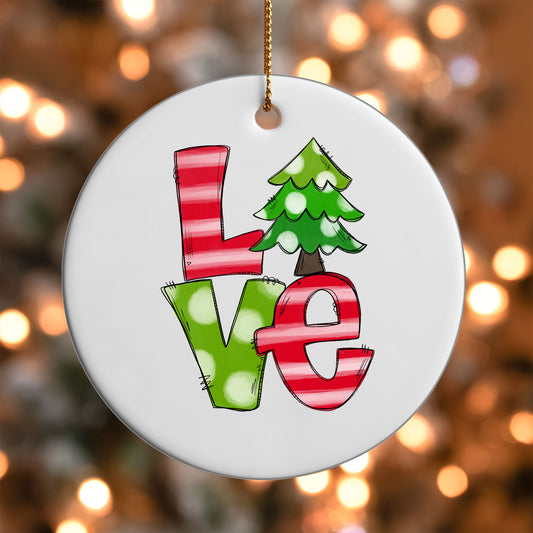 Christmas Love ornament UV DTF transfer on a round white ornament with a bokeh light background