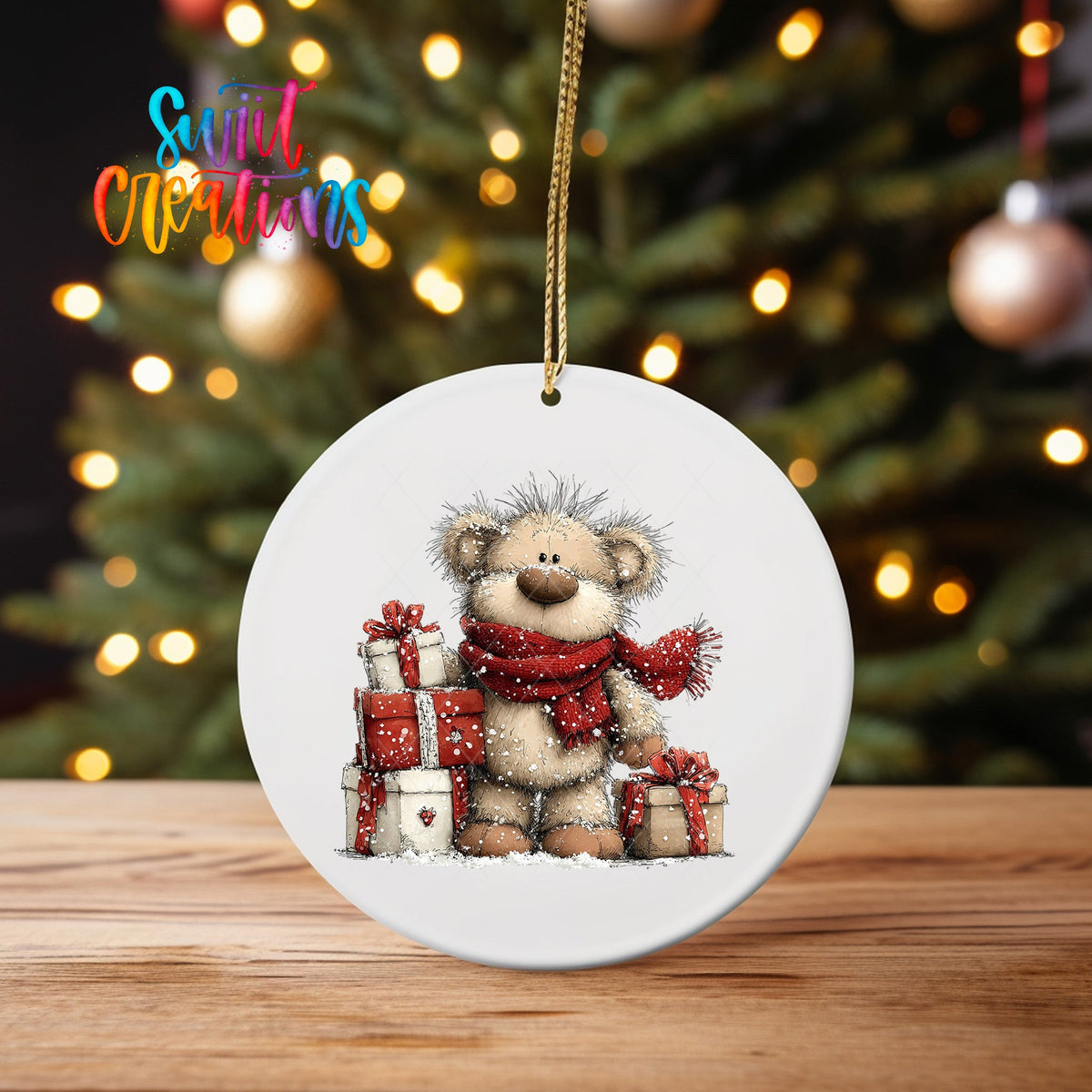 Teddy Bear with Gifts ornament UV DTF transfer on an ornament on a wooden table with tree lights behind it