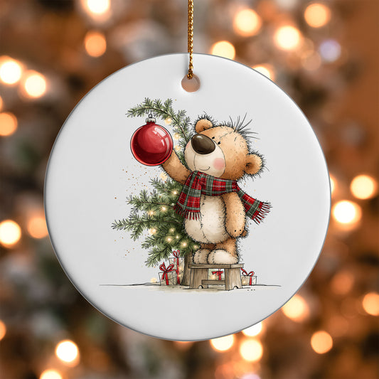 Christmas Tree Teddy Bear ornament UV DTF transfer on a round white ornament with a bokeh light background