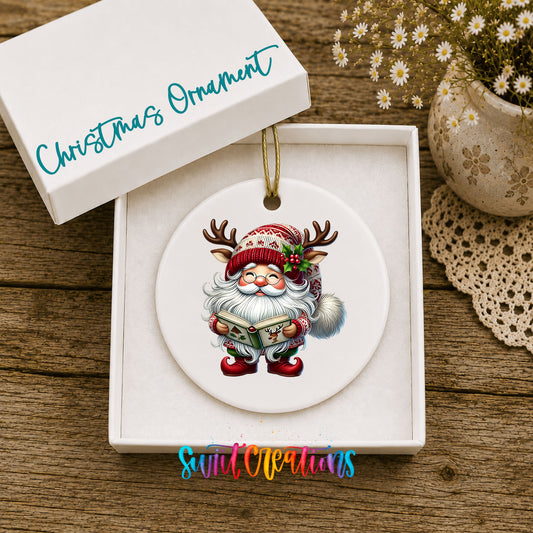 Santa reading a Christmas story ceramic ornament displayed in the included gift box