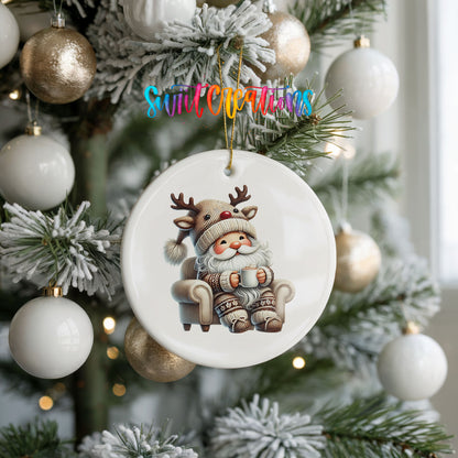 cozy Santa in a reindeer hat relaxing with a mug ceramic Christmas ornament hanging on a frosted holiday tree