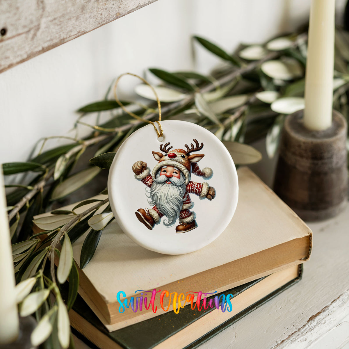 dancing Santa in a reindeer costume ceramic Christmas ornament styled on books with holiday greenery