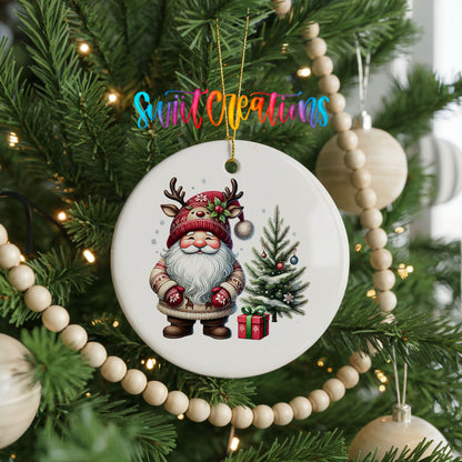 Santa beside a Christmas tree and wrapped gift ceramic Christmas ornament hanging on a decorated Christmas tree