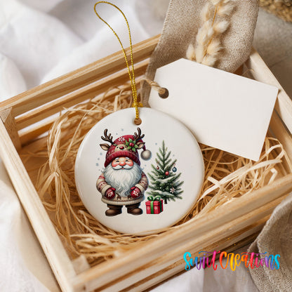 Santa beside a Christmas tree and wrapped gift ceramic Christmas ornament displayed in a rustic wooden gift crate