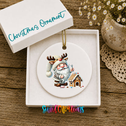 Santa decorating a gingerbread house ceramic Christmas ornament displayed in the included gift box
